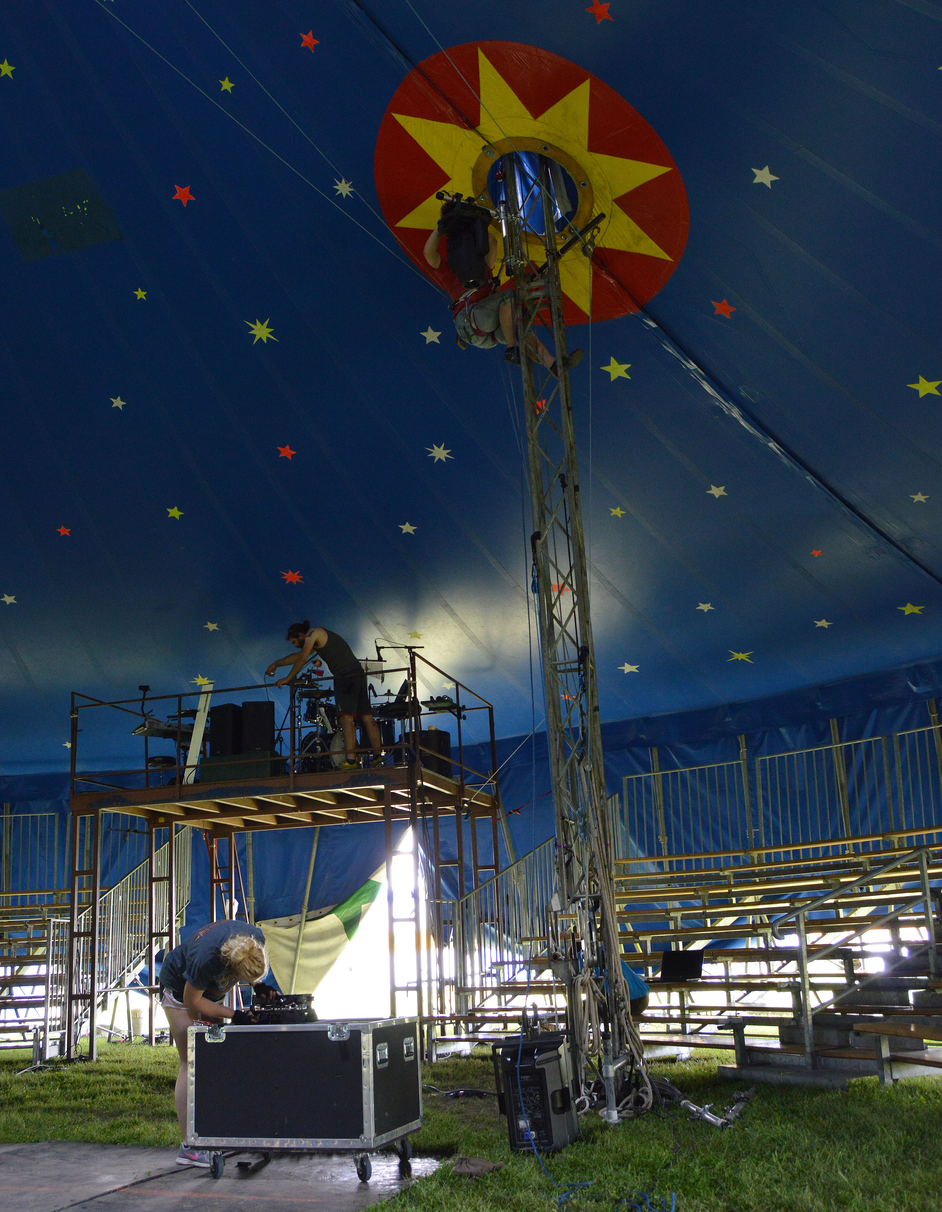 Members of our production team Jenna Raithel (ground), Jason Ekenroth (middle) and LeeAnne Brown (top) setting up lighting and sound equipment.