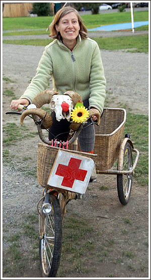 Alice Day rides around camp on her Cambulance, that has a basket in the back to transport the first aid kit, the medications and the cold packs from the farmhouse to the tents to the dorms.