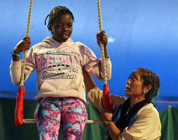 Estherline Carlson, 11, of Montpelier, gets instruction from Trapeze Coach Alyssa Luna at Circus Smirkus Camp. PHOTO BY AMIRA SILVERMAN
